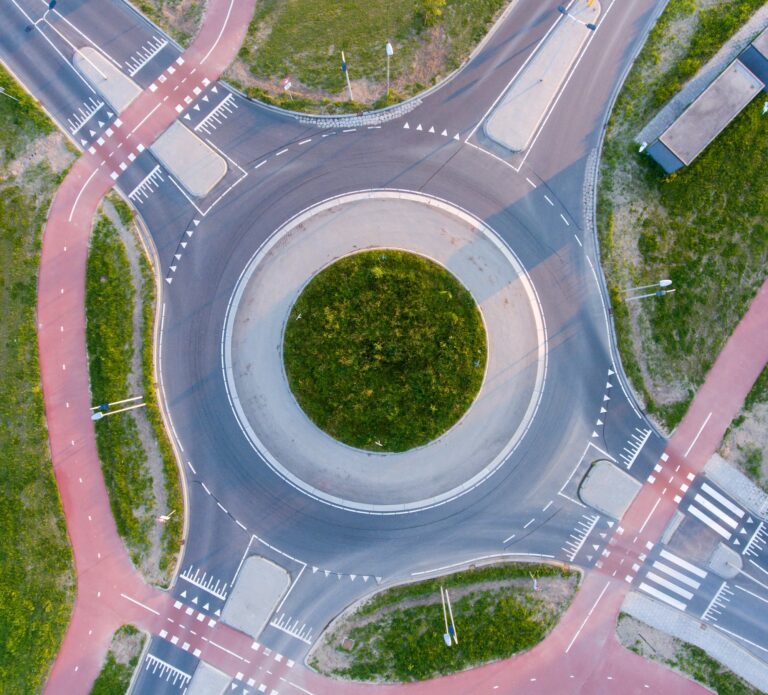 aerial-shot-roundabout-surrounded-by-greenery-sunlight-daytime