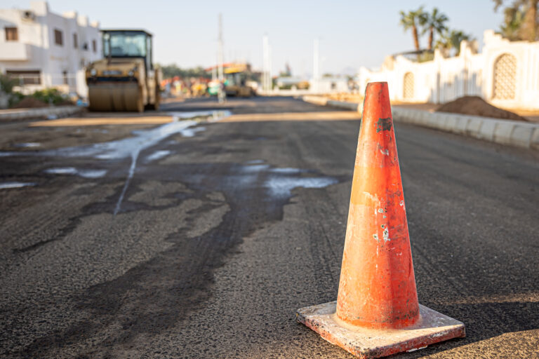 Close up of an orange traffic cone on the road